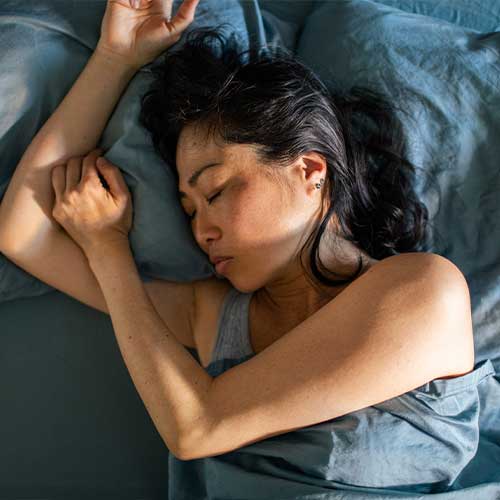 Close up of a Young Japanese woman waking up in the morning in a bedroom