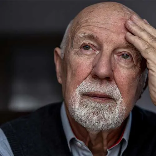 Portrait of a senior man suffering from a headache