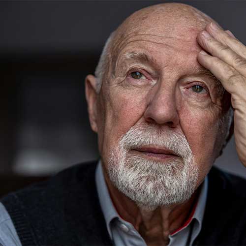 Portrait of a senior man suffering from a headache