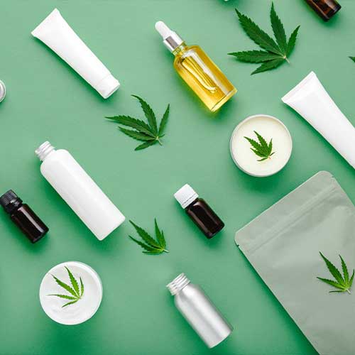 Hemp cbd oil serum in glass dropper bottle with cannabis leaves, Moisturizing cream, Serum, lotion, essential oil. Cannabis leaf with skincare cosmetic product Flat lay pattern on green background.