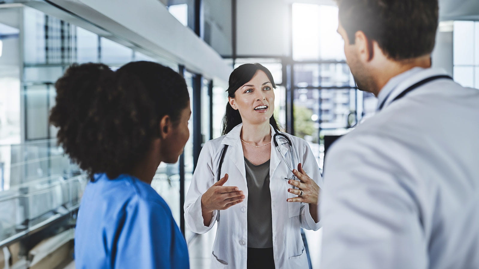 Doctors talking in a hospital atrium