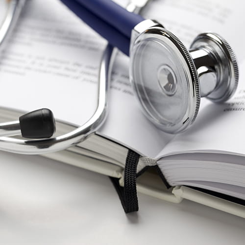 Stethoscope on a book.
