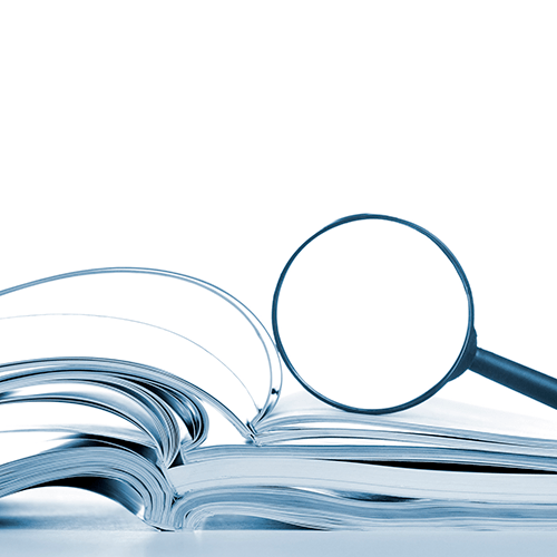 Opened magazines and magnifier glass, side view