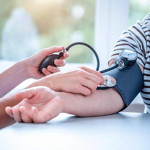Doctor measures a patient's blood pressure during a medical examination.