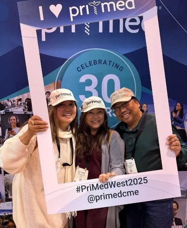 attendees at pri-med west smiling and taking a photo