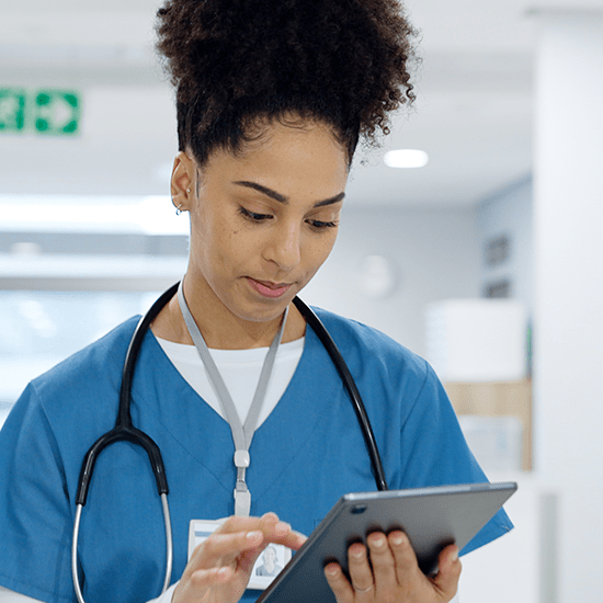 Medical student reading a tablet.
