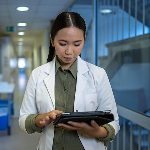 Medical student reading a tablet.