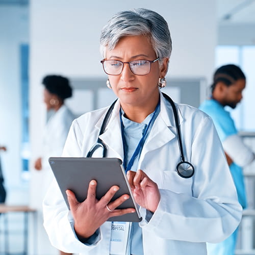 Doctor reading from a tablet.