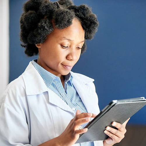 Medical student reading from a tablet.