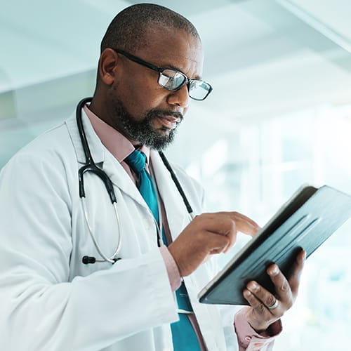 Doctor reading from a tablet.