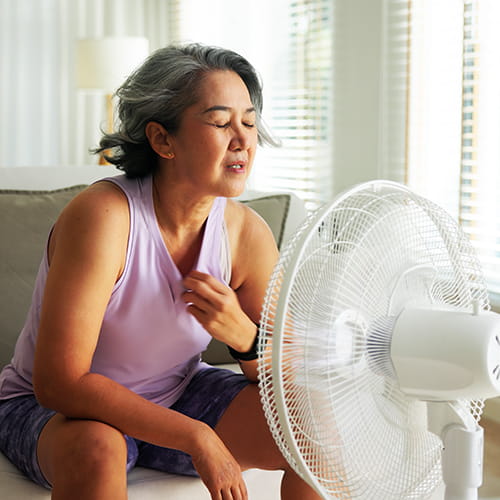 woman in front of fan