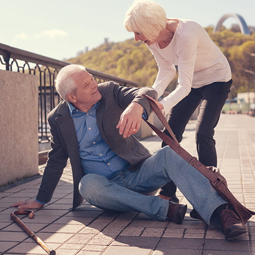 woman helping a man up after a fall