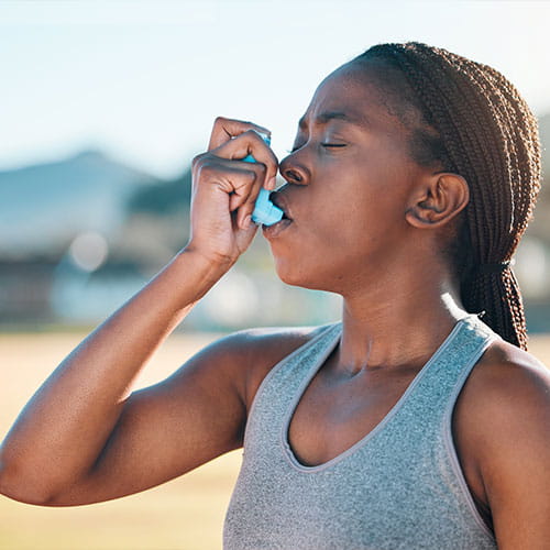 Fitness, breathe and black woman with asthma, inhaler or pump at sports court for training with lung problem. Exercise, deep breath and lady runner with medical relief from allergy respiratory issue