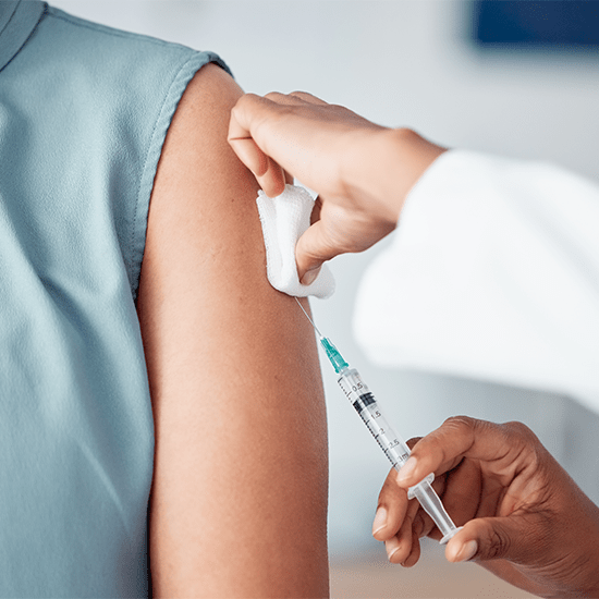 doctor giving patient a vaccine into arm