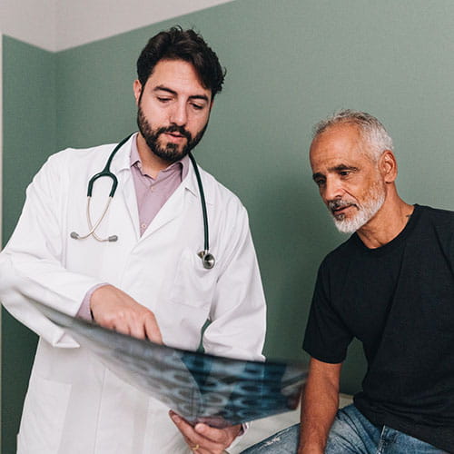 Doctor showing an x-ray image to his patient.