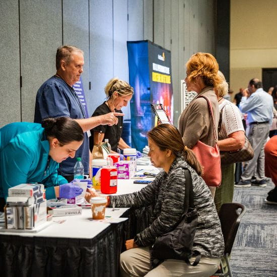 attendees engaging in product forum