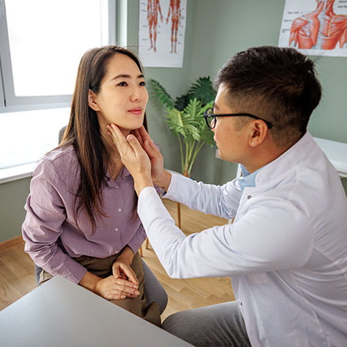 doctor checking patient's throat