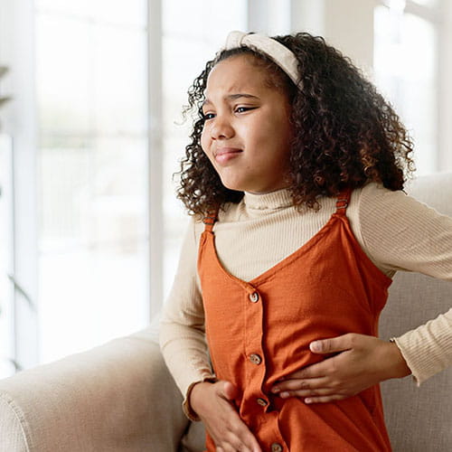 A little girl with a stomach ache.