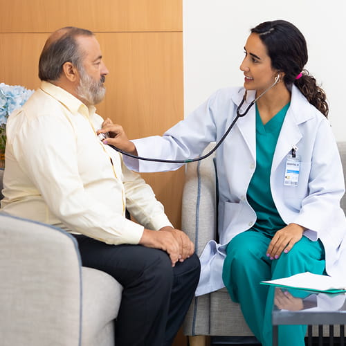 doctor listening to patients chest