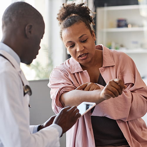 dermatologist looking at patients skin