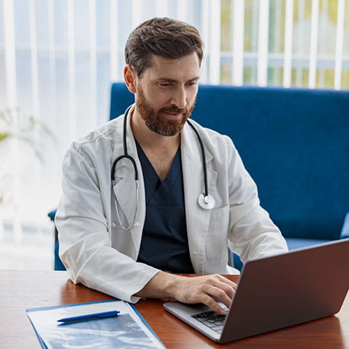 Doctor using a laptop in a medical office