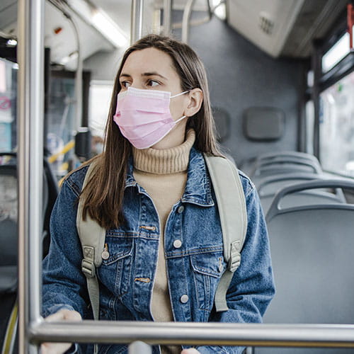 Woman with a mask on a bus