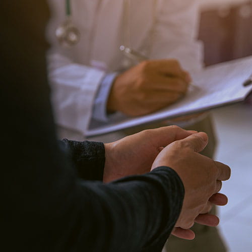 Doctor writing on a clipboard