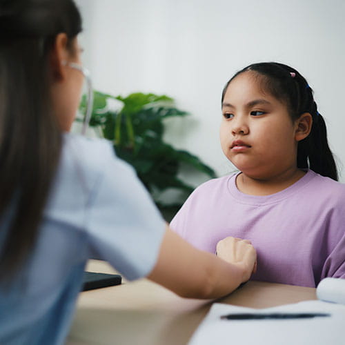 Doctor using stethoscope to listen to a child's heart