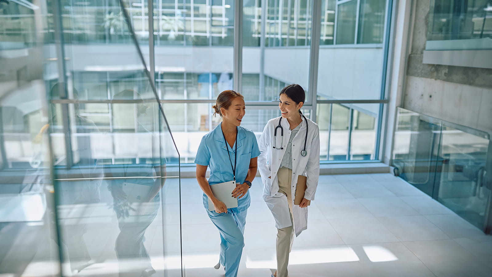 Clinicians walking up stairs in a hospital
