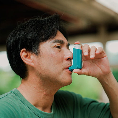 Man using an inhaler