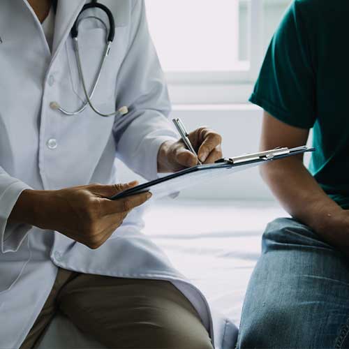 Male patient having consultation with doctor or psychiatrist who working on diagnostic examination on men's health disease or mental illness in medical clinic or hospital mental health service center