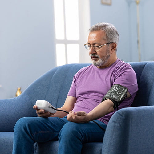 man taking his blood pressure at home