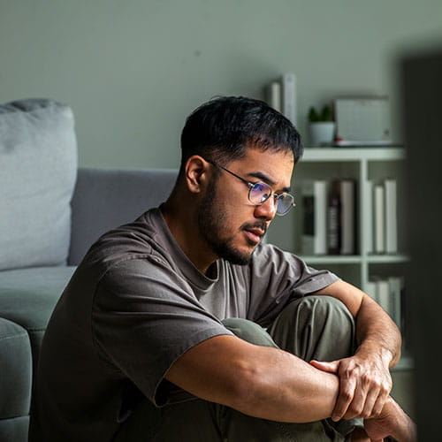 man sitting on his floor