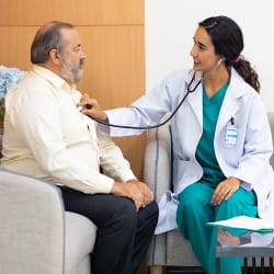 doctor listening to patients heart