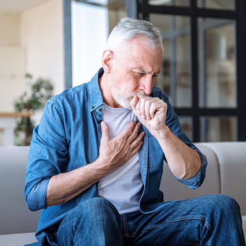 older man coughing