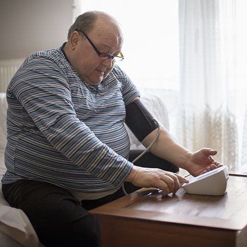 man taking blood pressure at home