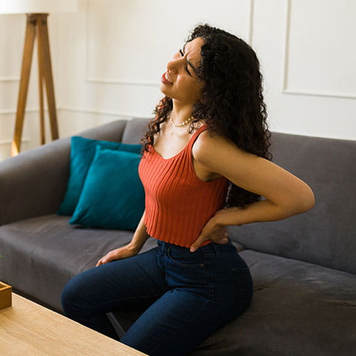 woman holding her back