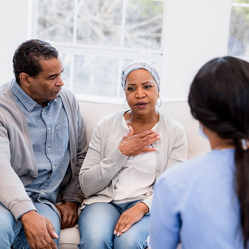 husband and wife talking to doctor