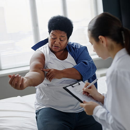 doctor examining a womans arm