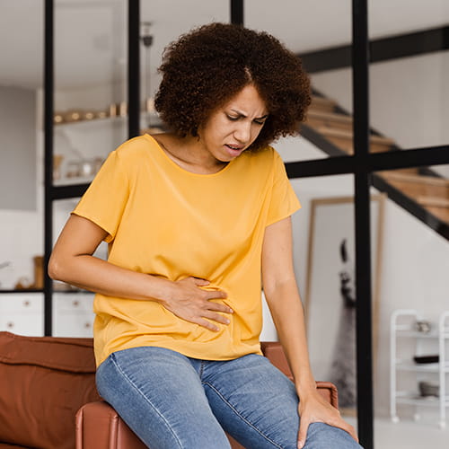 woman holding her abdomen