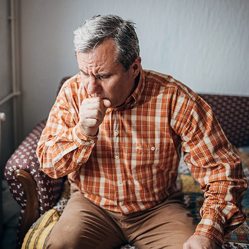 man coughing