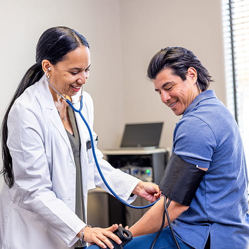 doctor taking a patients blood pressure