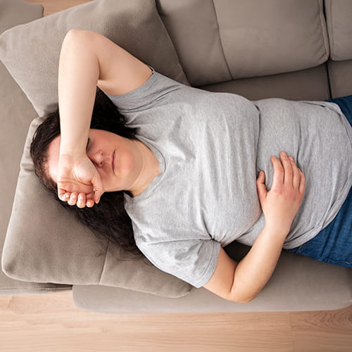 woman lying on couch