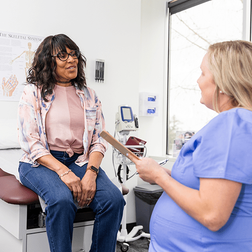 A patient talks to her doctor during a medical appointment.