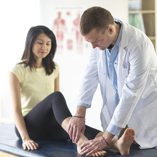 doctor examining patients ankle