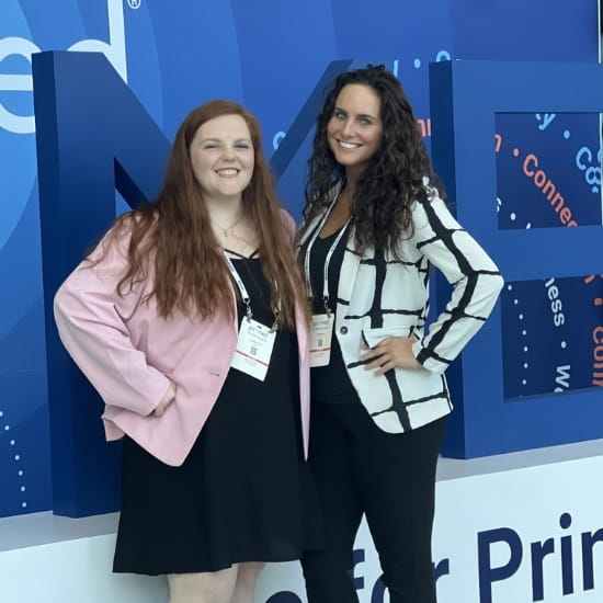 two attendees smiling at pri-med conference