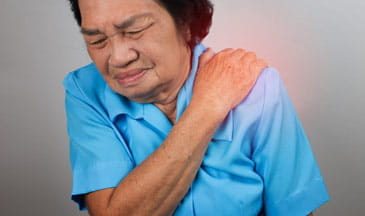middle aged hispanic woman with shoulder pain