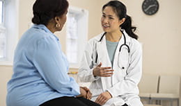 Doctor talks to African American patient